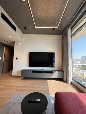 a living room with a large flat screen tv at Peaceful Modern Home Overlooking JVC Green Park in Dubai