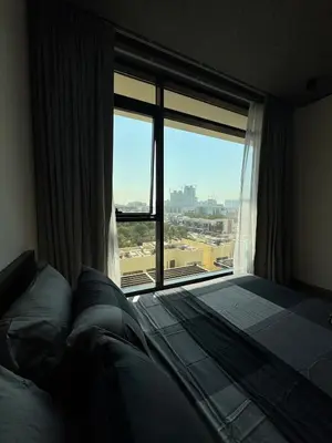 a bedroom with a bed and a large window at Peaceful Modern Home Overlooking JVC Green Park in Dubai