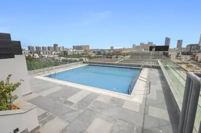 a swimming pool on the roof of a building at Peaceful Modern Home Overlooking JVC Green Park in Dubai