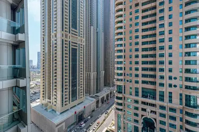 an aerial view of a city with tall buildings at StayMada - Ocean Heights Marina City and Sea Views in Dubai