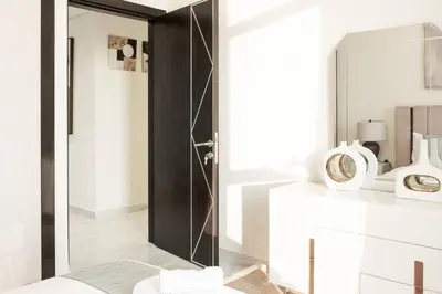 a bathroom with a glass door and a mirror at Gemz by Danube, Private Pool, Al Furjan - Onelink in Dubai