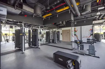 a gym with treadmills and machines in a room at Trendy & Brand new Studio In Business Bay in Dubai