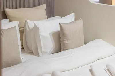 a pile of pillows on a bed in a room at Trendy & Brand new Studio In Business Bay in Dubai