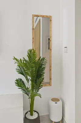 a bathroom with a mirror and a plant at Estudio Pearl en Dubai by beBalmy in Dubai