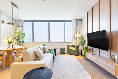 a living room with a couch and a flat screen tv at Designer's Selection - Luxury in the Heart of DIFC in Dubai