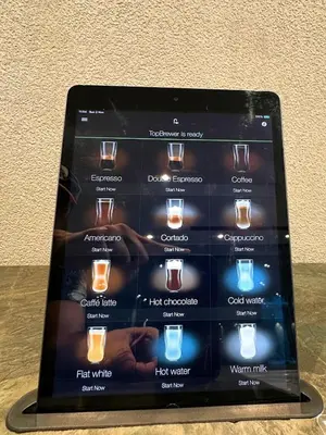 a tablet computer sitting on a table at Luxury Studio with Balcony, Pool, Coworking in JVC in Dubai