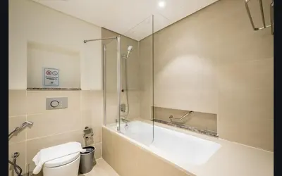 a bathroom with a shower and a toilet and a sink at Luxury 1025 sq feet 1 bed apartment in 29 floor Dubai Creek Residences in Dubai