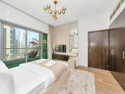 a bedroom with a large bed and a large window at Luxury Waterfront View w Ain Dubai and PS5 in JBR 5 min from the beach in Dubai