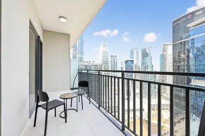 a balcony with a view of a city skyline at Golden Stays - Cozy 1BR Retreat I Skyline Views & Urban Charm in Dubai