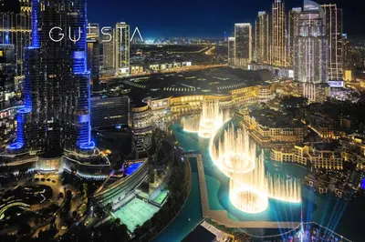 an aerial view of a city at night at Grande Tower by Emaar - Burj Khalifa and Fountain Views, Downtown Dubai in Dubai