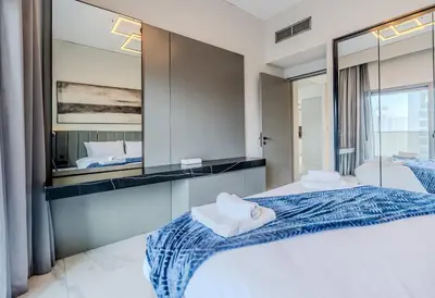 a bedroom with a large mirror and a bed at TRPS - MAG 318, Business Bay - Spacious 1BR plus Maids, Furnished, City View in Dubai
