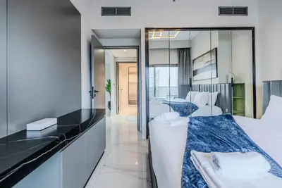 a hotel room with a bed and a mirror at TRPS - MAG 318, Business Bay - Spacious 1BR plus Maids, Furnished, City View in Dubai