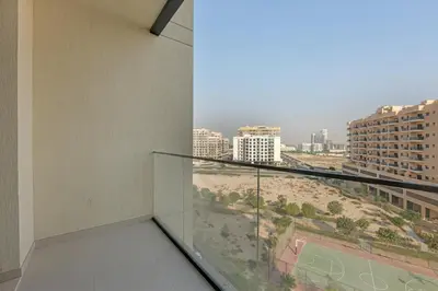 a balcony with a view of a beach and buildings at Lux 1 Bedroom Apartment in Majan in Dubai
