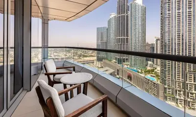 a balcony with chairs and tables and a view of a city at Dubai Mall 5 star Free Parking in Dubai