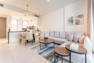 a living room with a couch and a table at Glimpse of Burj Khalifa 2BR, 15-Minute Drive to Burj Khalifa and Downtown Landmarks, District One Phase III Residences 13, Mohammed Bin Rashid Al Maktoum City by Deluxe Holiday Homes in Dubai