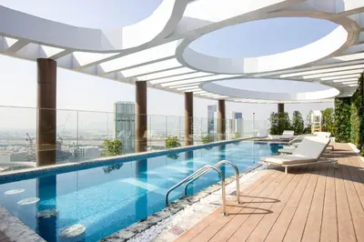 a swimming pool on the roof of a building at Luxury 1BR High Floor Rooftop Pool Access in Dubai