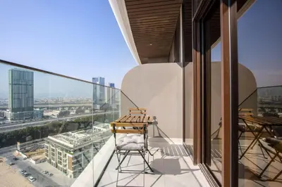 a chair on the balcony of a building at Luxury 1BR High Floor Rooftop Pool Access in Dubai