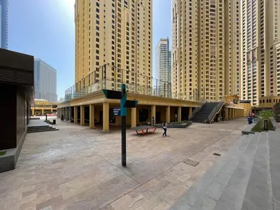 a building in the middle of a city with tall buildings at GuestReady | 2BR | Stunning Canal View, JBR in Dubai