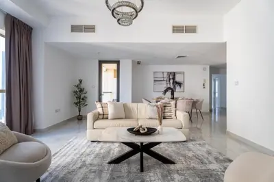 a living room with two couches and a table at GuestReady | 2BR | Stunning Canal View, JBR in Dubai