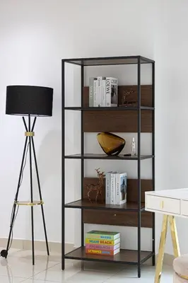 a black book shelf next to a lamp at Luxury Marina Views Near Mall & Beach, with Gym, Swimming Pool & Car Park in Dubai