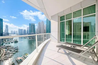 a balcony with a bench and a view of the water at Luxury Marina Views Near Mall & Beach, with Gym, Swimming Pool & Car Park in Dubai