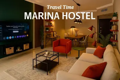 a living room with a couch and a tv at TravelTime Marina in Dubai