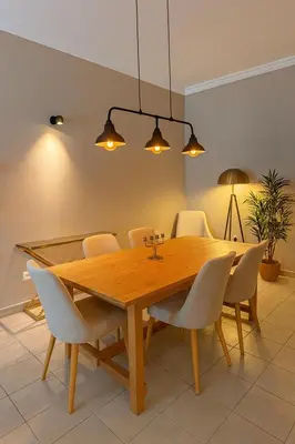 a dining room with a wooden table and chairs at TravelTime Marina in Dubai