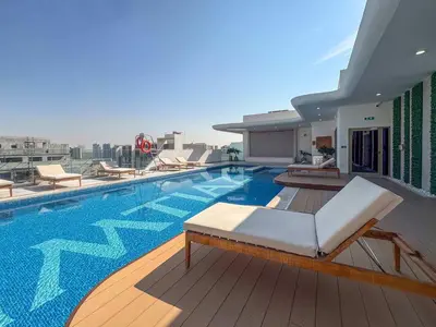 a swimming pool on the roof of a building at Frank Porter - Pearl House in Dubai