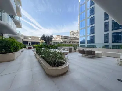 a courtyard in a building with tables and chairs at Frank Porter - Pearl House in Dubai