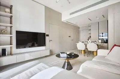a living room with a couch and a tv at Frank Porter - Pearl House in Dubai