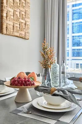 a dining table with a plate of fruit on it at Frank Porter - Westside Marina in Dubai