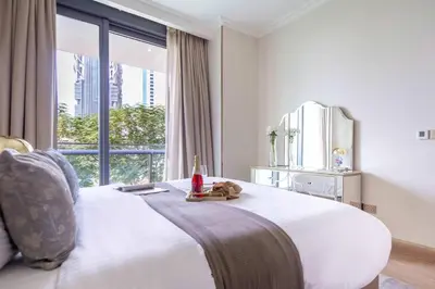 a bedroom with a large white bed with a window at Frank Porter - Burj Vista Tower 2 in Dubai