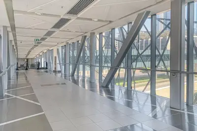 an empty hallway in a large building with windows at Frank Porter - Burj Vista Tower 2 in Dubai
