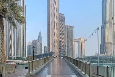 a bridge in the middle of a city with tall buildings at Frank Porter - Burj Vista Tower 2 in Dubai
