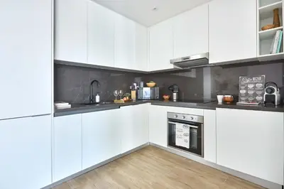 a white kitchen with white cabinets and an oven at Frank Porter - Marina Diamond 4 in Dubai