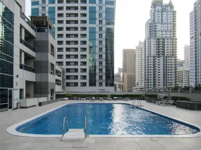 a large swimming pool in a city with tall buildings at Frank Porter - Marina Diamond 4 in Dubai