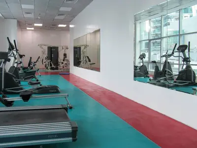 a gym with treadmills and elliptical machines at Frank Porter - Marina Diamond 4 in Dubai