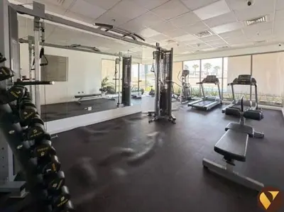 a gym with several treadmills and machines in a room at Vogue JVC Jeewar Tower Near Circle Mall, One Bedroom Apartment with Balcony and City View, Access to all Amenities in Dubai