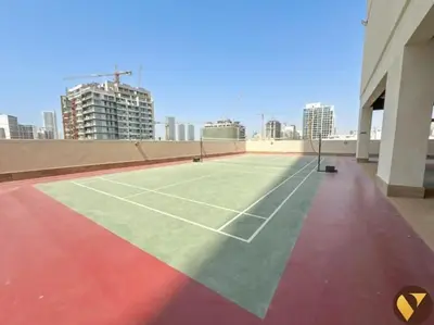 a tennis court on the roof of a building at Vogue JVC Jeewar Tower Near Circle Mall, One Bedroom Apartment with Balcony and City View, Access to all Amenities in Dubai