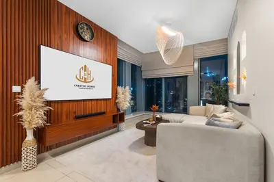a living room with a tv and a couch at Exclusive 2BR I Panoramic Views I Downtown Dubai in Dubai