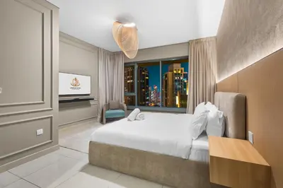 a hotel room with a bed and a window at Exclusive 2BR I Panoramic Views I Downtown Dubai in Dubai