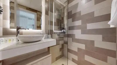 a bathroom with a sink and a shower at Séjour raffiné et inoubliable in Dubai