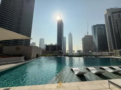 a large swimming pool in a city with tall buildings at Evasion Moderne a Business Bay vue sur le canal in Dubai