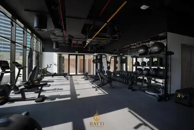 a gym with lots of treadmills and weights at Evasion Moderne a Business Bay vue sur le canal in Dubai