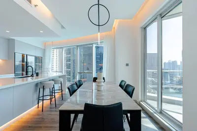 a kitchen and dining room with a table and chairs at 2 BR Superb and Luxury Dubai Marina View in Dubai