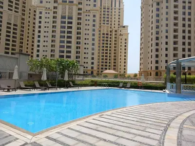 a large swimming pool with tall buildings in the background at 2 BR Superb and Luxury Dubai Marina View in Dubai