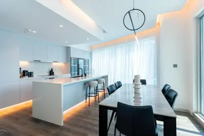 a kitchen and dining room with a table and chairs at 2 BR Superb and Luxury Dubai Marina View in Dubai