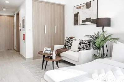 a living room with a couch and a table at Azizi Riviera 5, Meydan Close to Downtown - Onelink in Dubai