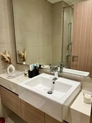 a bathroom with a white sink and a mirror at Azizi Riviera Studio High Floor Partial Burj View in Dubai