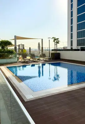 a large swimming pool on top of a building at Azizi Riviera Studio High Floor Partial Burj View in Dubai